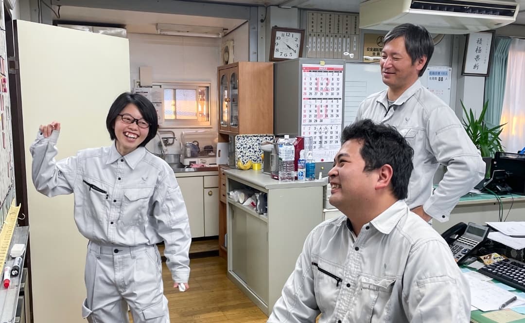 笑い合いながらスケジュールを確認する作業員の様子